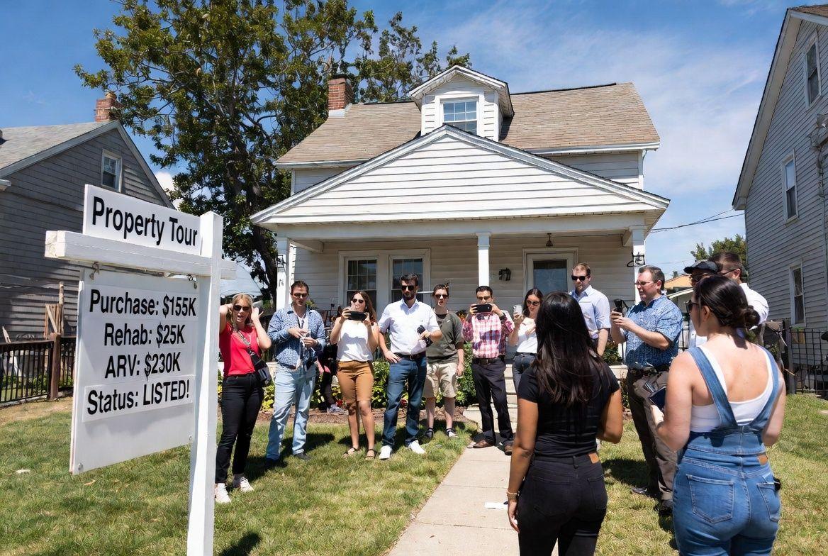A group gathered outside a property during an educational tour